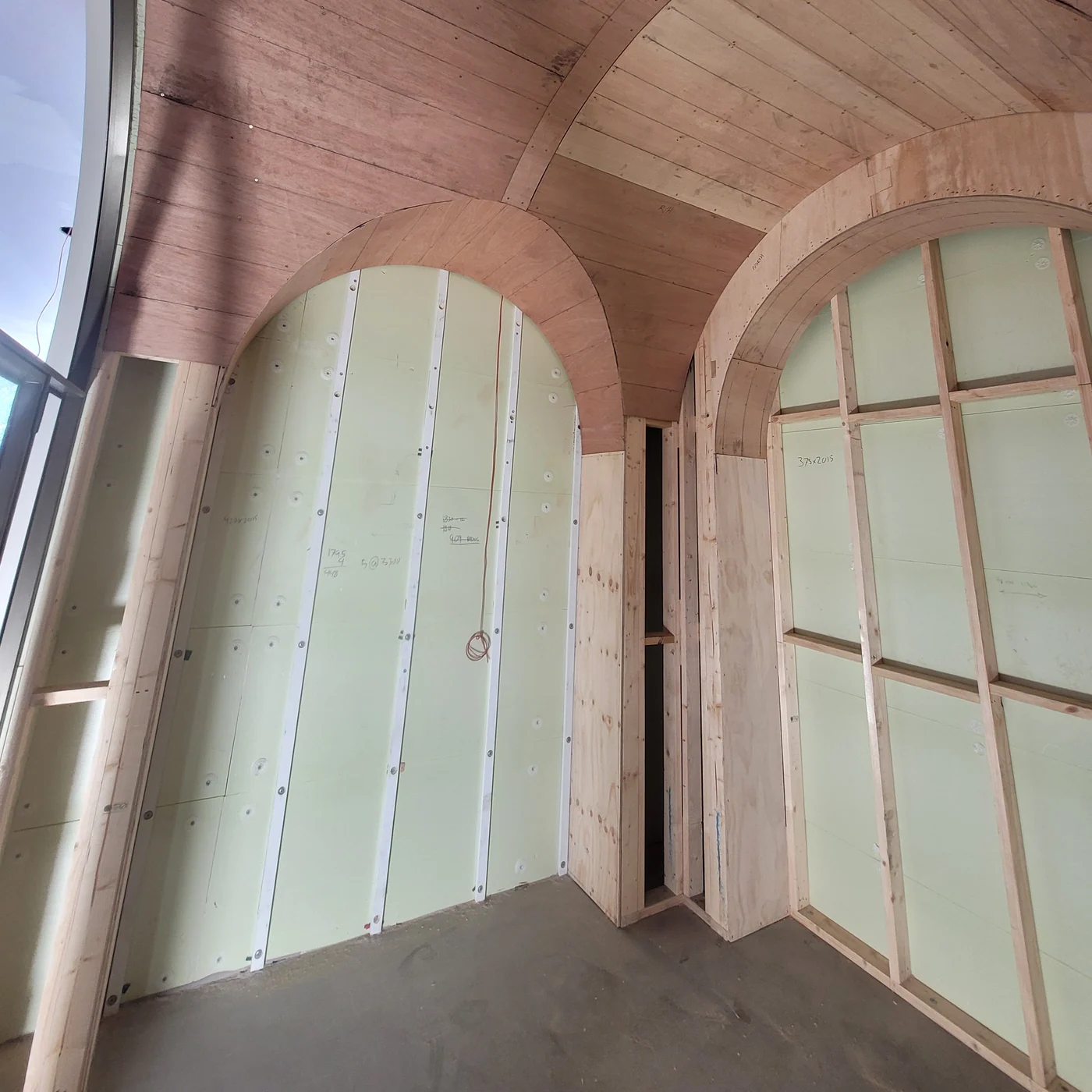 Arched window framing and timber-lined ceiling