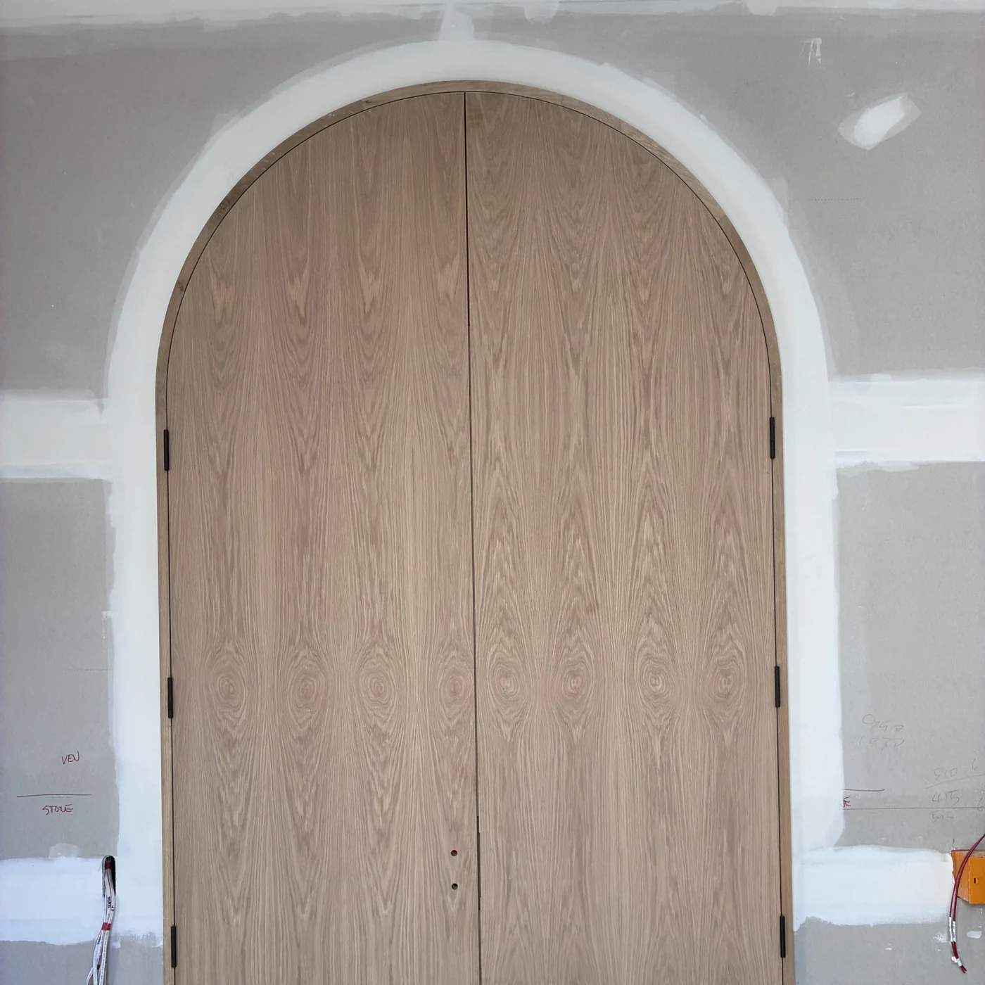 Custom arched timber door fitted cleanly