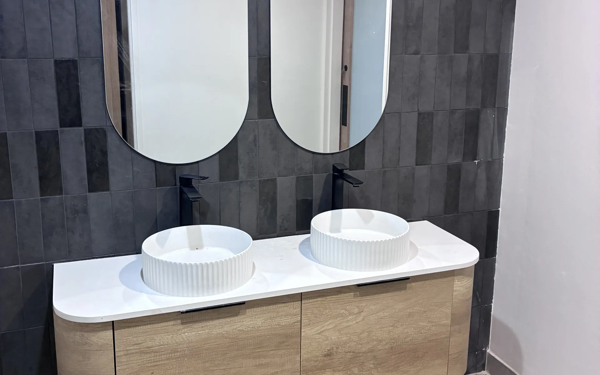 Renovated bathroom with twin basins and timber vanity