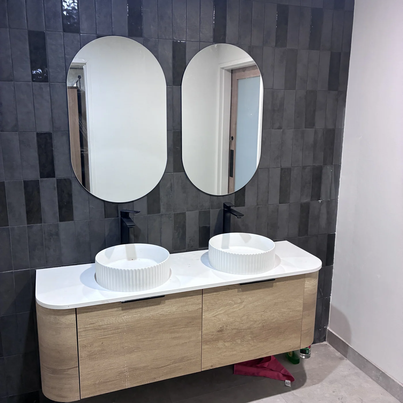 Finished bathroom with twin basins and timber vanity