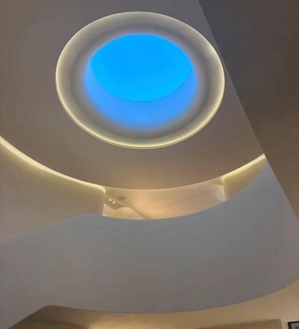 Curved plaster ceiling with a circular skylight, custom carpentry work