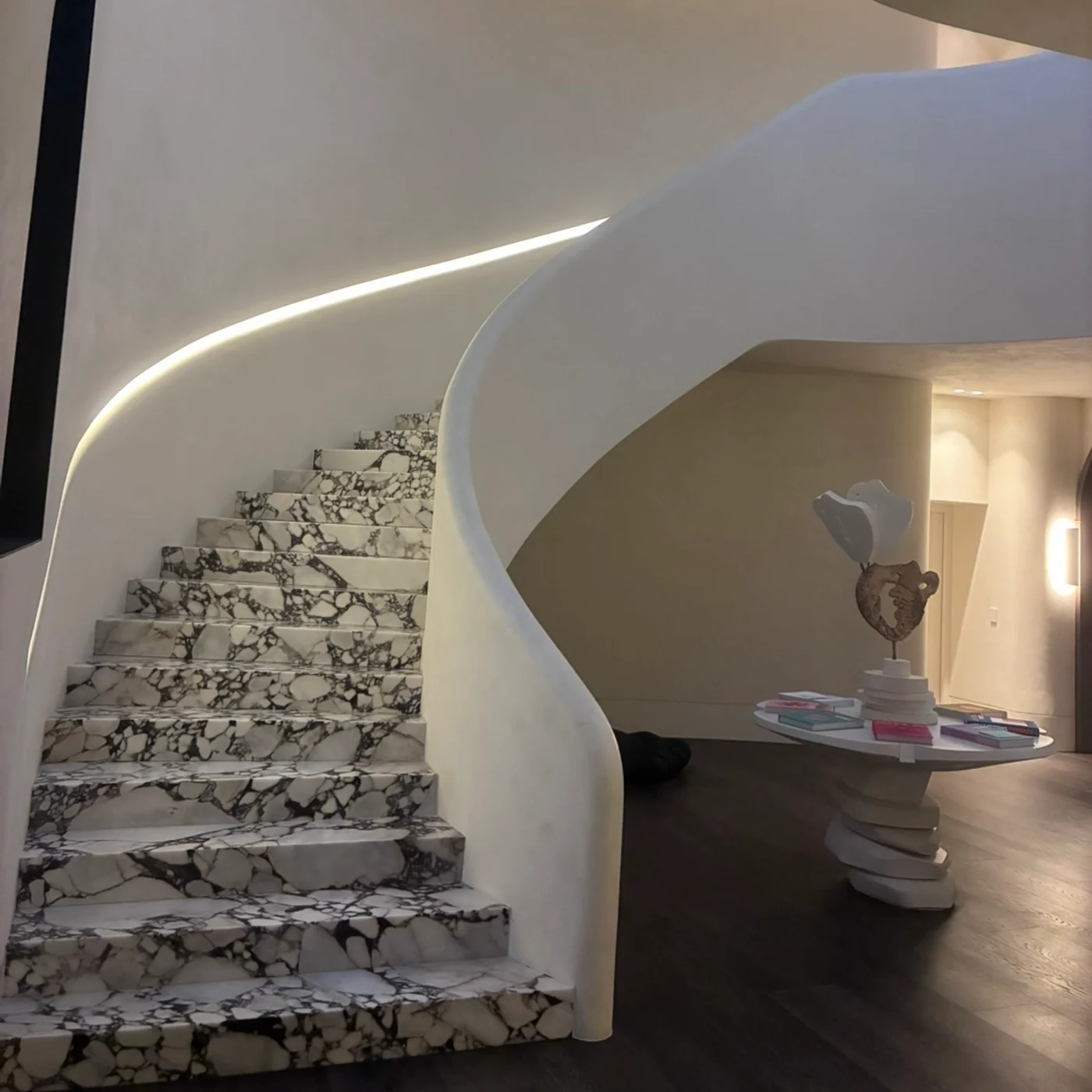 Curved plaster staircase and custom carpentry