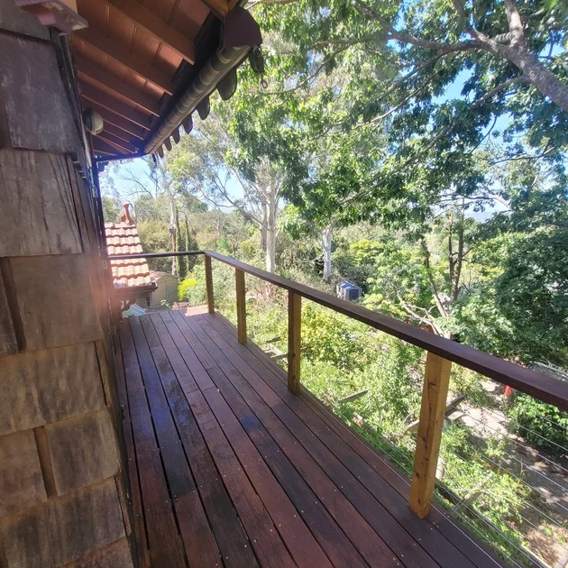 Elevated timber deck with wire balustrade and bush views