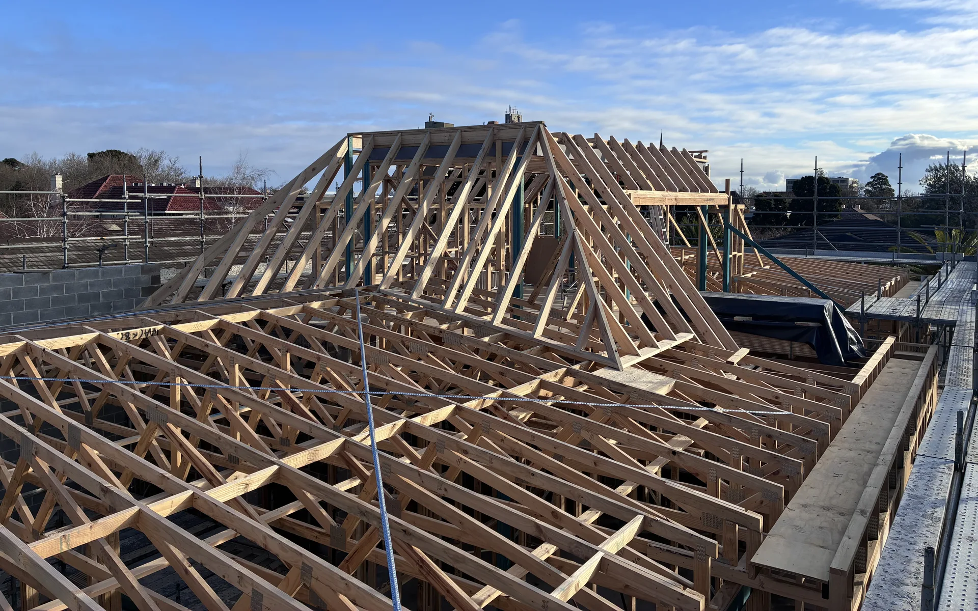 Extension roof framing against a blue sky