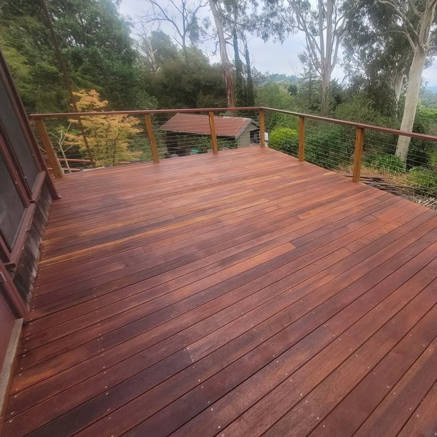 Hardwood deck overlooking a treed garden